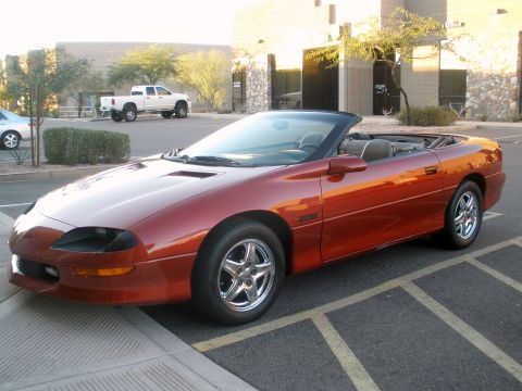1983 Jeep CJ7 - This orange convertible, identified by its Z28 badging, is shown in a three-quarter front view.