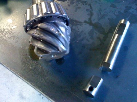 1987 Suzuki Samurai - Close-up of a differential pinion gear and bearing assembly, with a separate shaft component.