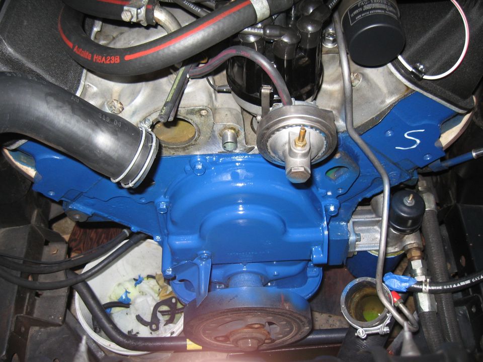 Blue painted engine block with hoses and a pulley visible