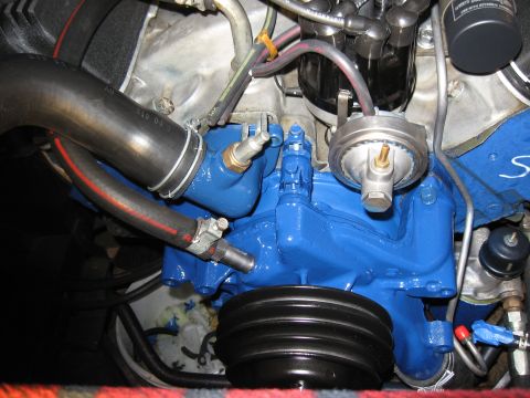 1968 Shelby GT500 - A close-up view of engine components, including hoses and a pulley, with some parts painted bright blue.