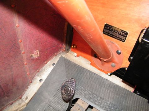 1913 Ford Model T - Interior view of a 1913 Ford Model T, showing the floor mat, pedals, and an orange support bar.