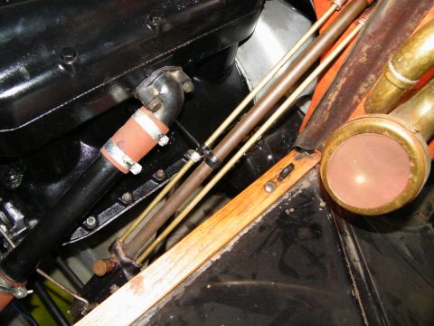 1913 Ford Model T - Close-up view of the engine compartment and a brass lamp on a 1913 Ford Model T.