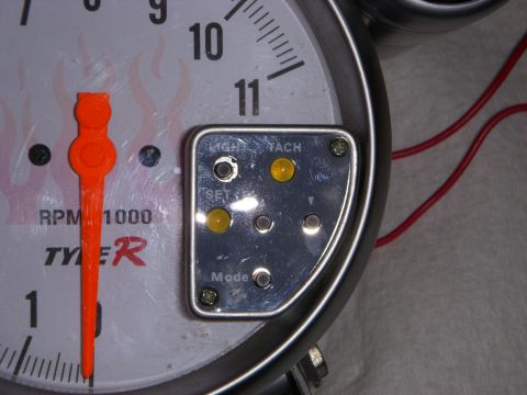 1995 Ford Bronco - A close-up view of a tachometer gauge shows its dial and control buttons.