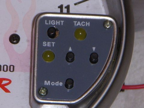 1995 Ford Bronco - Close-up of a tachometer gauge with control buttons and indicator lights.