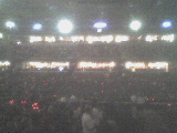 2004 Land Rover Land Rover - A large crowd fills the stadium seating area, illuminated by overhead lights.