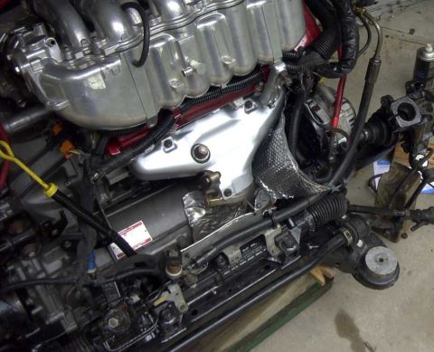 1997 Ford Taurus - A close-up view of a complex engine assembly, likely from a Ford Taurus, showing intricate metalwork, wiring harnesses, and various engine…