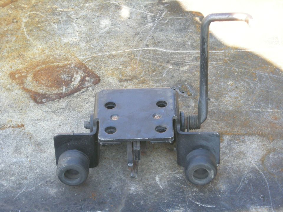 Black metal bracket with rubber mounts and bent arm