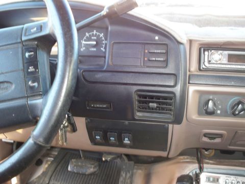 1996 Ford Bronco - The interior of a 1996 Ford Bronco shows the driver's side dashboard with the steering wheel, instrument cluster, and center console visibl…