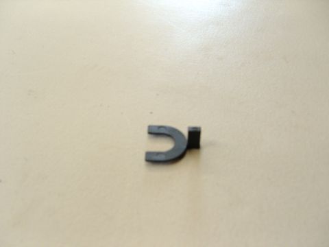 2007 Ford Mustang - Photograph of a small black plastic U-shaped retainer clip, not a technical document.