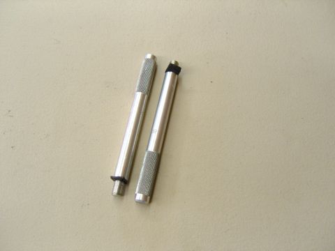 2007 Ford Mustang - Photograph of two knurled metal pin/alignment tools, not a technical document.