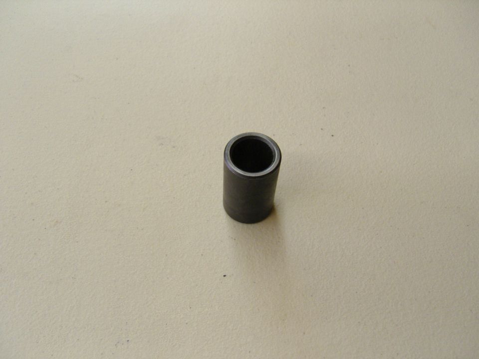 Photo of a short black cylindrical metal spacer bushing