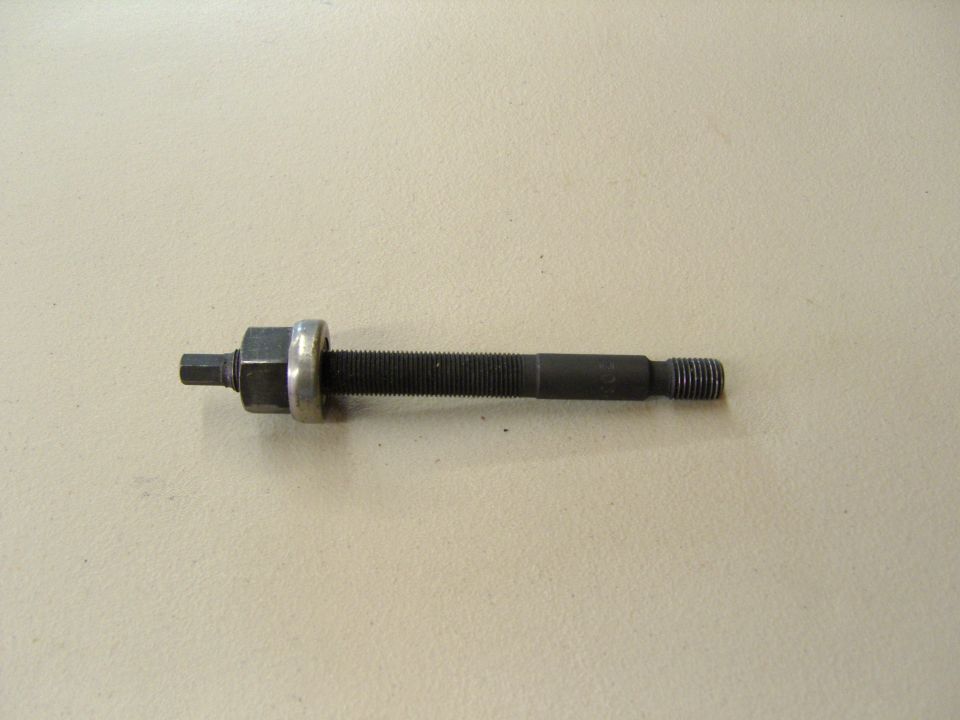 Photo of a threaded puller or jack screw with hex head and washer