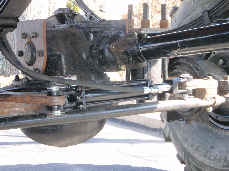 Heavy-duty vehicle front axle with differential, driveshaft, and hydraulic steering
