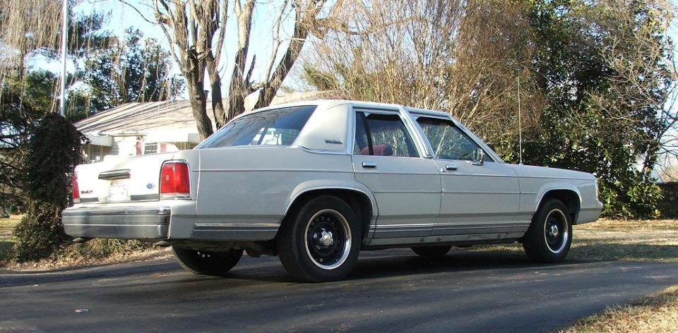 1991 Ford Crown Victoria LTD sedan, rear passenger side view, light color