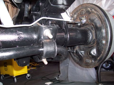 1978 Ford Bronco - Close-up view of a vehicle's rear axle and brake system components.