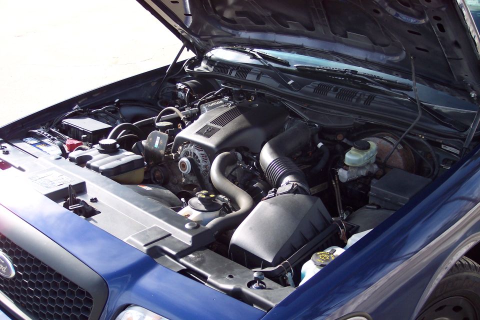 Blue 2001 Ford Crown Victoria engine bay with hood open, showing V8 engine components