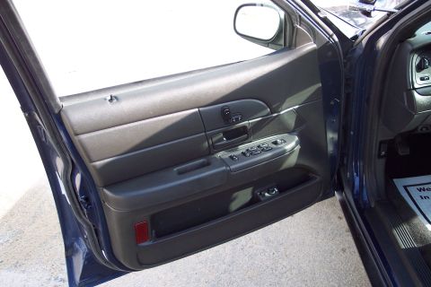 2001 Ford Crown Victoria - Interior view of the driver's side door panel on a 2001 Ford Crown Victoria.