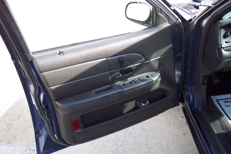 2001 Ford Crown Victoria interior door panel with power window controls and side mirror