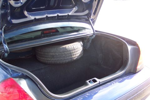2001 Ford Crown Victoria - Trunk interior of a 2001 Ford Crown Victoria, showing the spare tire compartment.