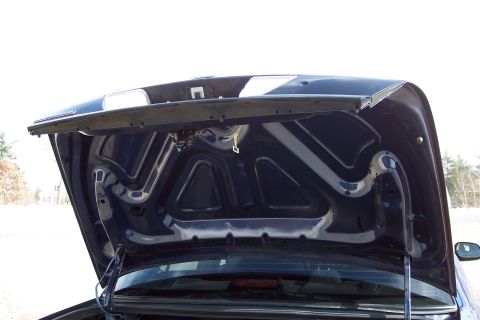 2001 Ford Crown Victoria - The underside of a dark blue car hood is visible, with the trunk area below.