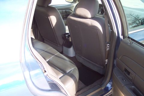 2001 Ford Crown Victoria - Interior view of the rear seats and door panel of a blue 2001 Ford Crown Victoria.