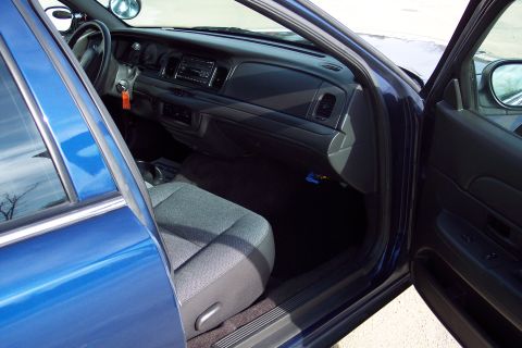2001 Ford Crown Victoria - Interior view of a blue 2001 Ford Crown Victoria, with the driver's side door ajar.