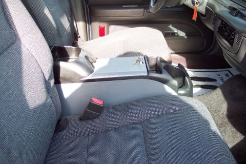 2001 Ford Crown Victoria - The interior of a car shows the front seats, center console, and dashboard area.