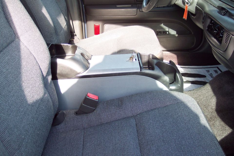 Front seats and center console of a car. Keys are in the console