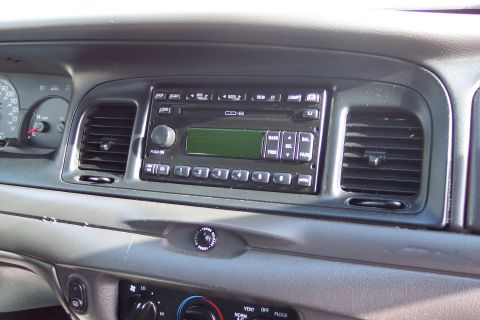 2001 Ford Crown Victoria - The interior dashboard of a 2001 Ford Crown Victoria features a CD-6 radio, air vents, and instrument cluster.