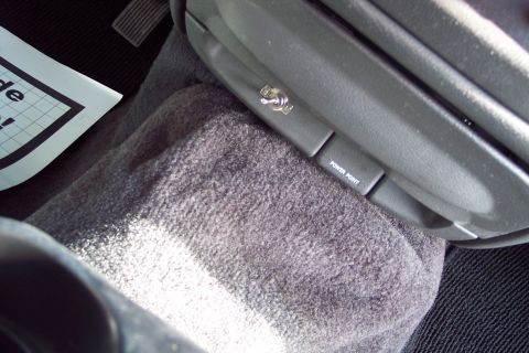 2001 Ford Crown Victoria - The center console of a vehicle features a toggle switch and a power point outlet.