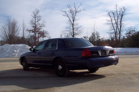 2001 Ford Crown Victoria - Dark blue 2001 Ford Crown Victoria parked outdoors in a snowy landscape.
