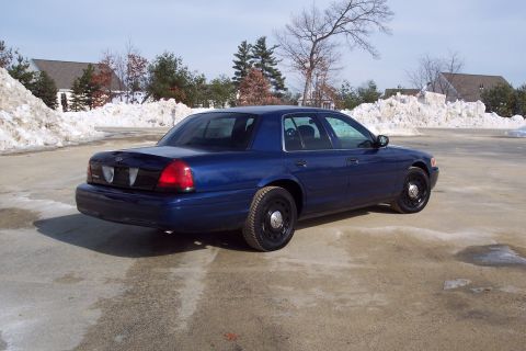 2001 Ford Crown Victoria - A blue 2001 Ford Crown Victoria is parked outside on a cold day with snowbanks visible.