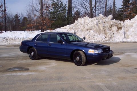 2001 Ford Crown Victoria - Dark blue 2001 Ford Crown Victoria in a snowy outdoor setting.