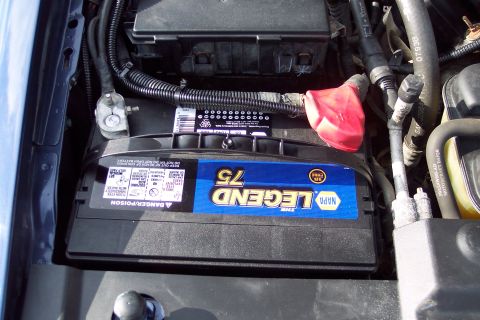 2001 Ford Crown Victoria - Close-up of a NAPA LEGEND 75 battery in the engine bay, with visible wiring and hoses.