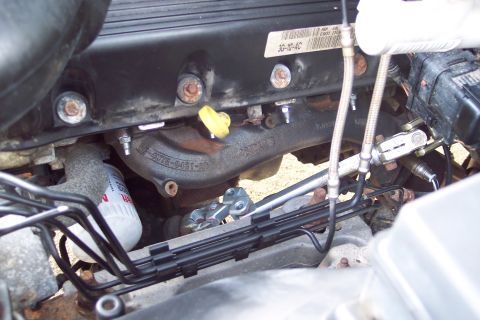 2001 Ford Crown Victoria - Exhaust manifold and oil filter visible in engine bay.