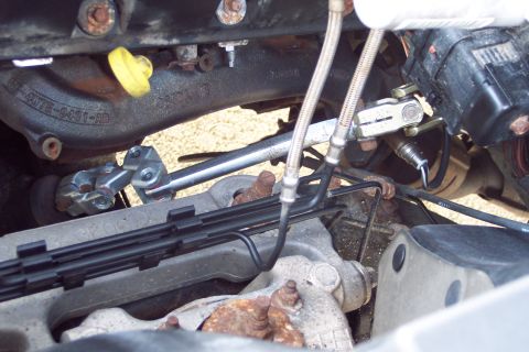 2001 Ford Crown Victoria - This image shows a close-up view of various engine and steering components, including an exhaust gas sensor.