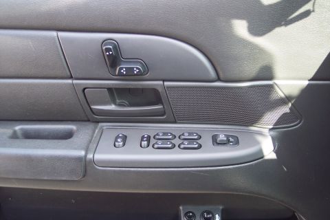 2001 Ford Crown Victoria - Close-up of a car's interior door panel, showing various electronic controls.