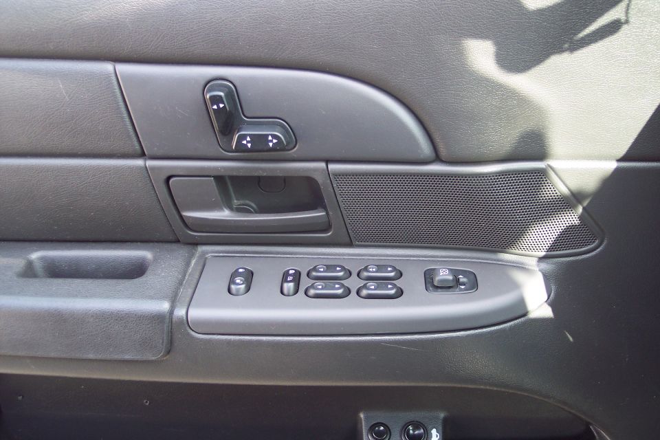 Car door panel with power window and seat controls