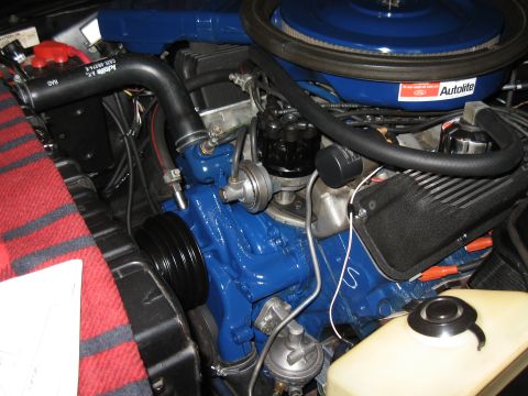 1968 Shelby GT500 - Close-up of an engine bay, a blue cover and red and white components.