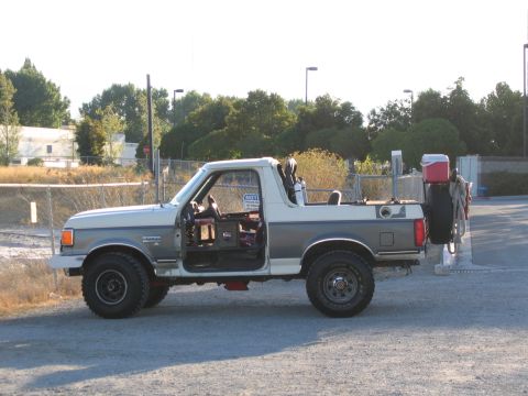 1991 Ford Bronco - Side view of a 1991 Ford Bronco with the driver's door ajar.