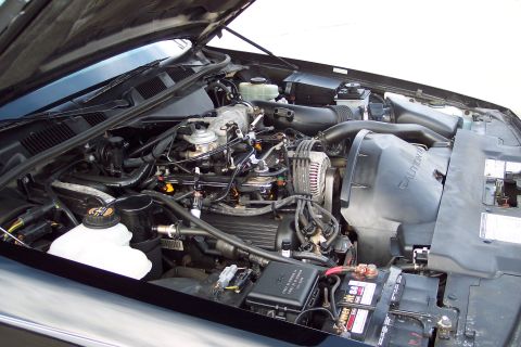 2001 Ford Crown Victoria - Close-up view of the engine compartment, showing various mechanical parts and wiring.
