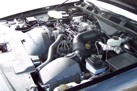 2001 Ford Crown Victoria - The engine bay of a 2001 Ford Crown Victoria, the air intake system and brake fluid reservoir.