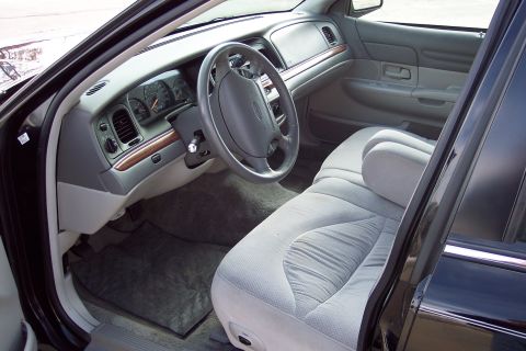 2001 Ford Crown Victoria - Interior view of a 2001 Ford Crown Victoria, showing the dashboard, steering wheel, and front seats.
