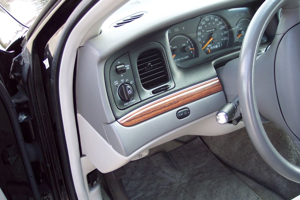 2001 Ford Crown Victoria interior dashboard with wood trim and gauges