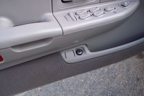 2001 Ford Crown Victoria - Interior view of a car door panel, showing window controls and a key lock mechanism.