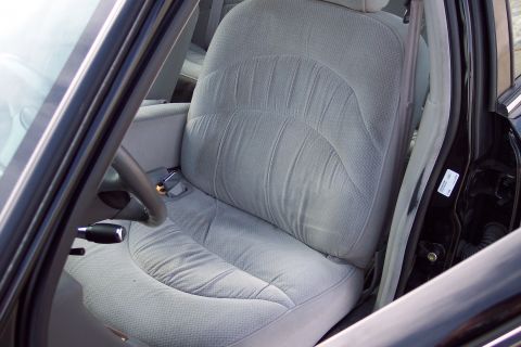 2001 Ford Crown Victoria - Interior view of a car's driver's side, showing cloth seats and door jamb details.