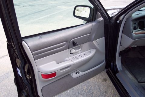 2001 Ford Crown Victoria - View of the driver's side interior door panel and part of the dashboard of a Ford Crown Victoria.