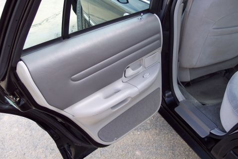 2001 Ford Crown Victoria - Interior shot showing the door panel and seat of a car.