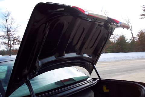 2001 Ford Crown Victoria - The underside of a car's trunk lid is visible, with the trunk interior below.
