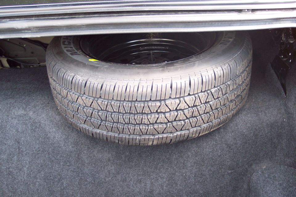 Spare tire with Michelin branding in a car's trunk